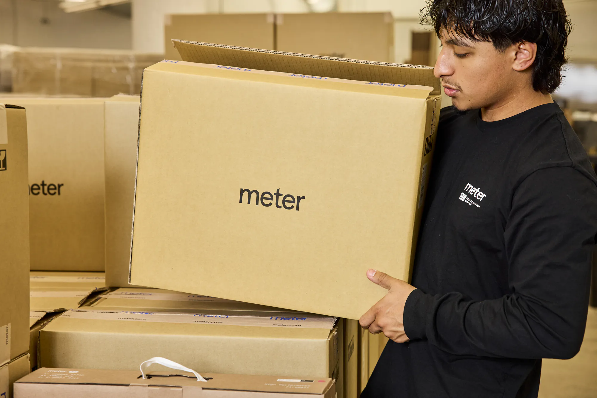 Warehouse crew unboxing a new shipment of Meter hardware
